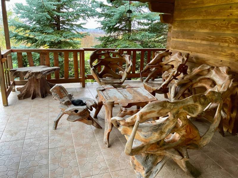Wooden furniture on the porch overlooking the greenery in the recreational grounds in Čereňany - Fančová.
