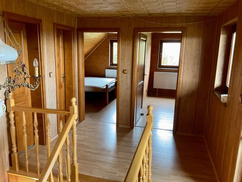 Interior with wooden paneling, floor with wooden decor, entrance to the room. Recreational grounds.