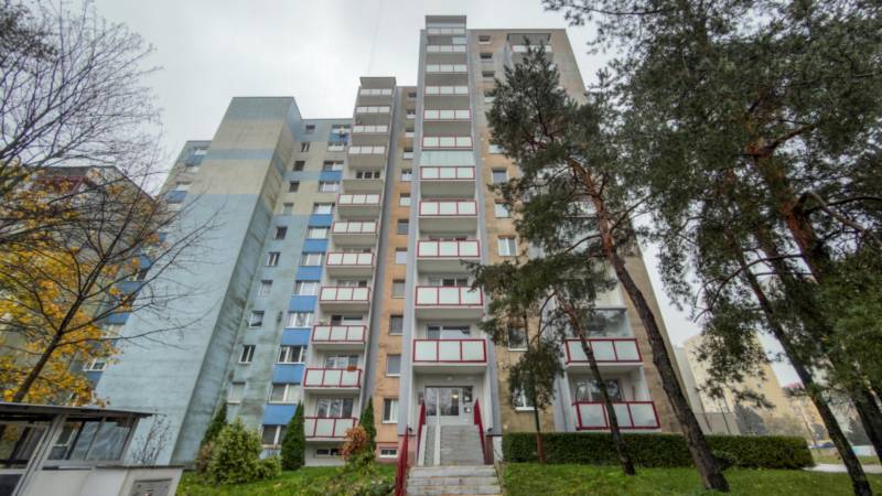 An apartment building in Bratislava, Dúbravka on Drobného Street, surrounded by trees and greenery.