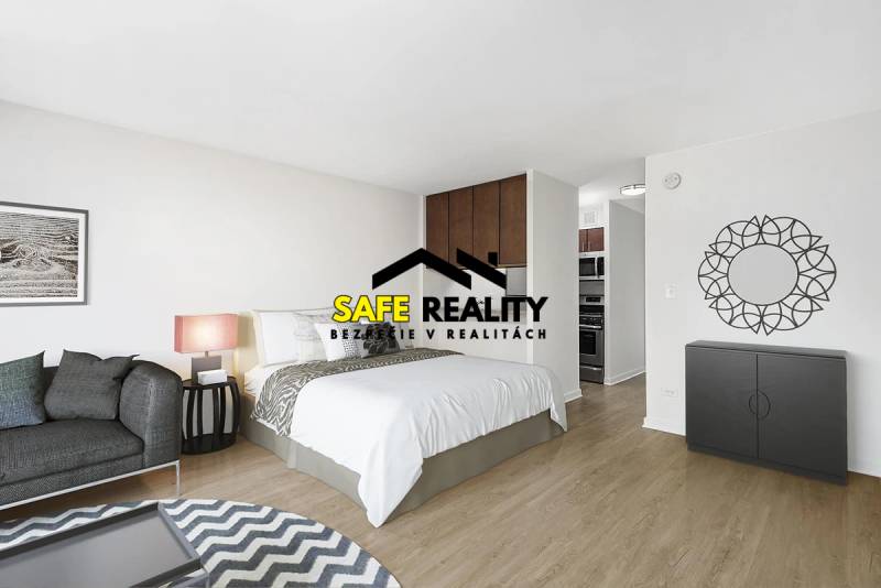 A one-room apartment with a bed, a sofa, and a wooden decor floor in a light interior.