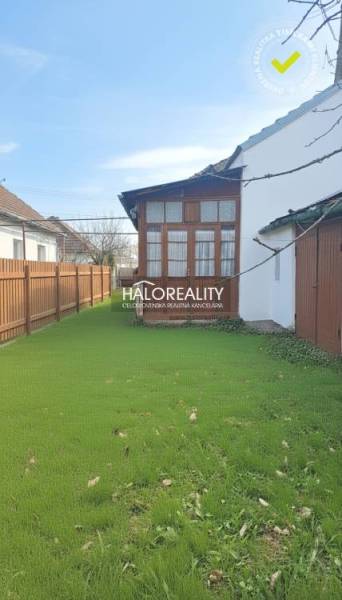 A family house in Rimavská Sobota with a spacious garden and a wooden fence.