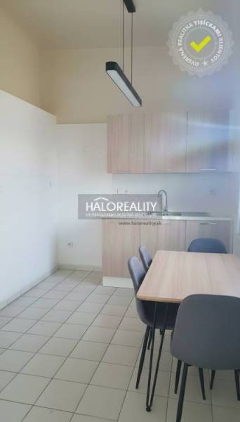 A kitchen in a family house with a simply furnished dining table and chairs.