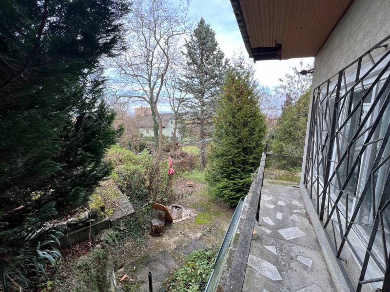 A cottage in Bratislava - Devínska Nová Ves on the street Pod Srdcom, surrounded by trees and plants.