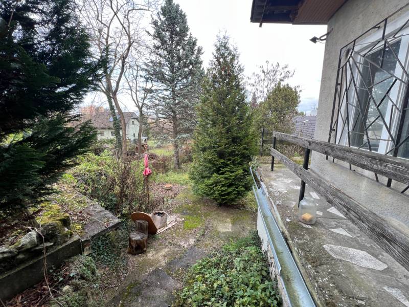 The garden at the cottage on Pod Srdcom Street, Bratislava - Devínska Nová Ves, surrounded by trees.