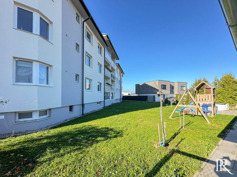 Apartment building on Železničná Street in Trenčianska Turná with a lawn and a children's playground.