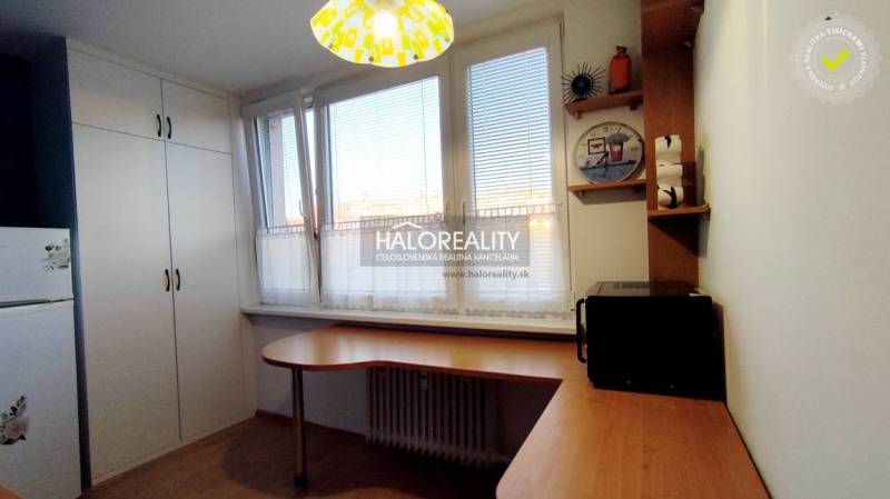 Kitchen and a 2-room apartment, containing furniture, a microwave, and cabinets with storage space.