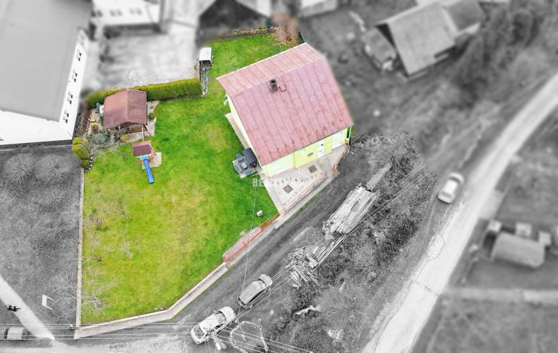 Aerial view of a family house in Kysucké Nové Mesto with a garden and a children's playground.