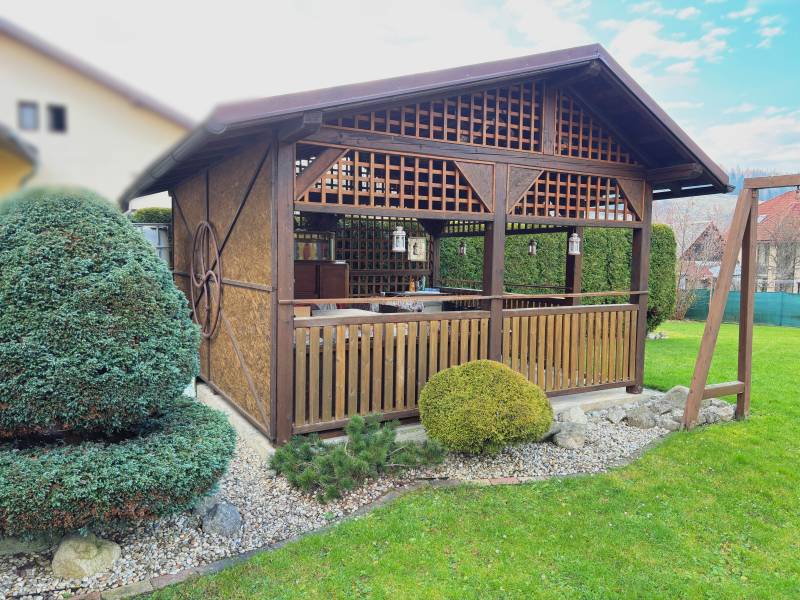 The garden of a family house in Kysucké Nové Mesto with a wooden gazebo and well-maintained lawn.
