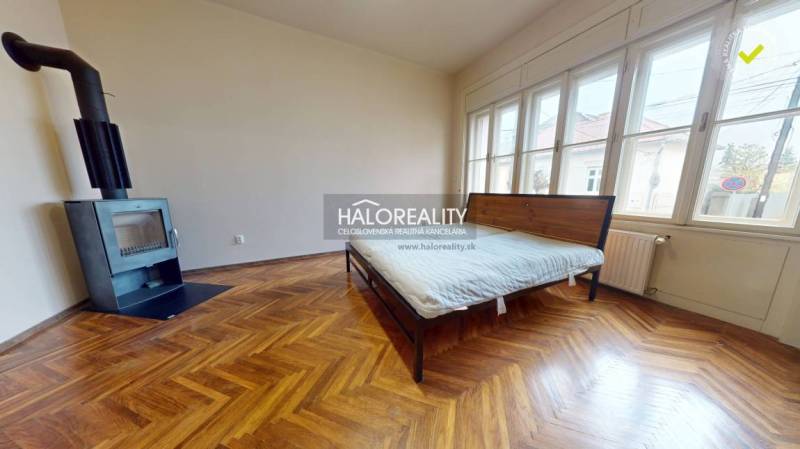 The bedroom in the 3-room apartment is complemented by a fireplace and a wooden decor floor.