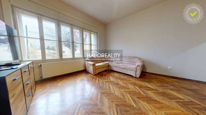 Living room in a 3-room apartment with a wooden decor floor and a sofa.