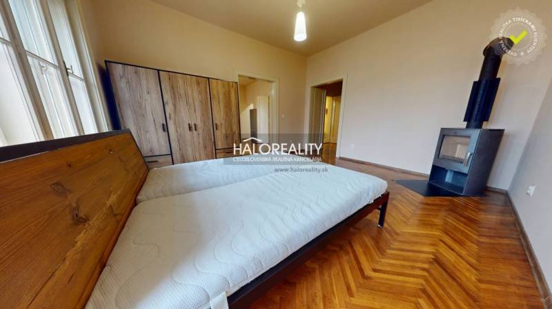 A bedroom in a 3-room apartment with a bed, a wardrobe, and a floor with a wooden decor.