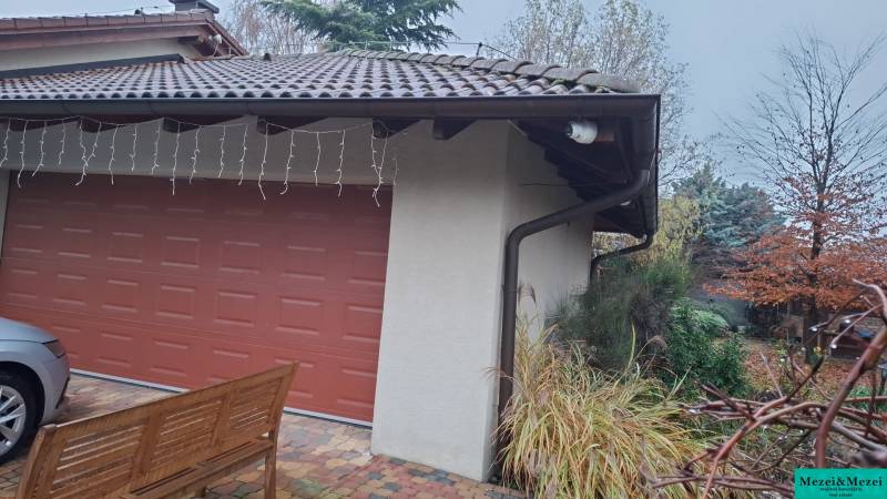 Family house in Bohdanovce nad Trnavou, garage with a red door, surrounding greenery.