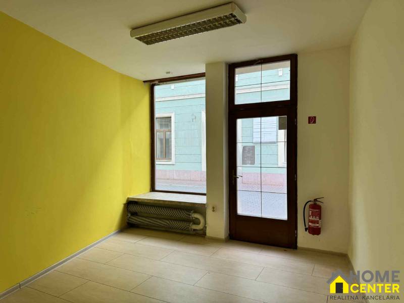 Commercial premises with tiles and radiators, suitable for business.