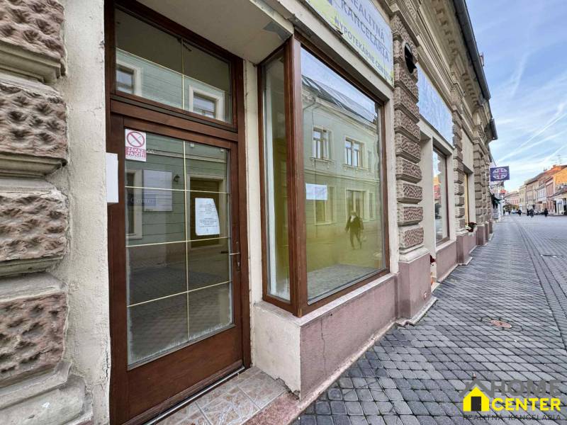 The exterior of commercial premises on Župná Street in Komárno with glass doors.