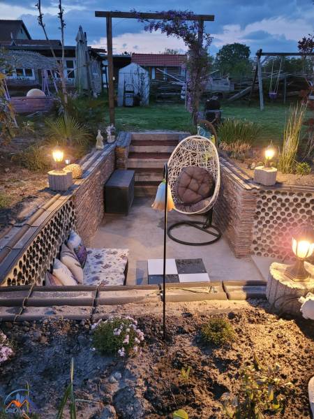 A family house in Okoličná na Ostrove with illuminated outdoor seating and garden design.