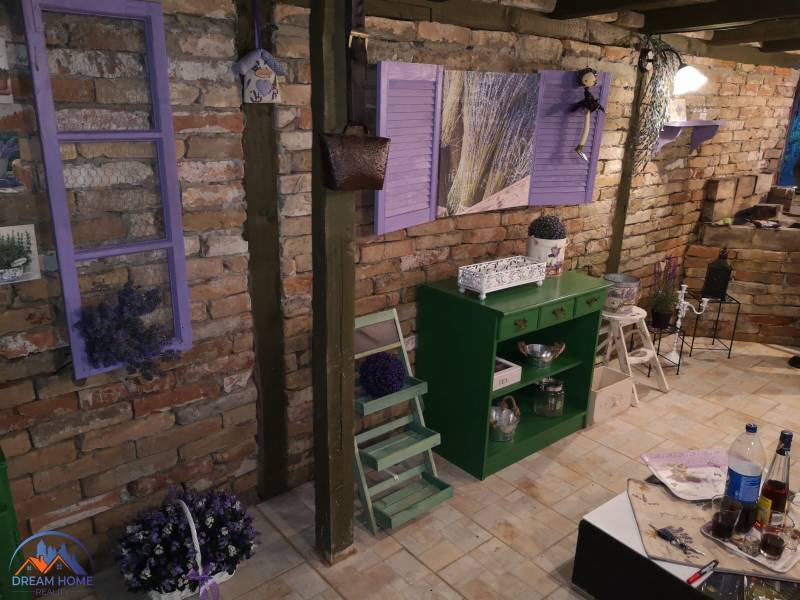 Brick wall and lavender decorations in the interior of a family house with flooring.