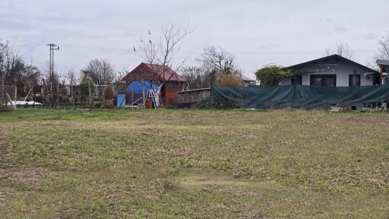 Grassy plot with wooden and brick structures on Recreational lands in Drahovce.