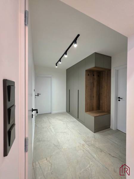 Hallway in a 3-room apartment with a built-in wardrobe and spot lighting.