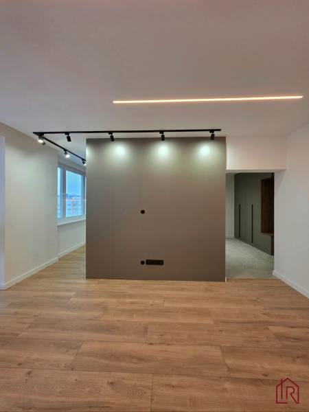 3-room apartment with lighting, wall, and floor with wood decor.