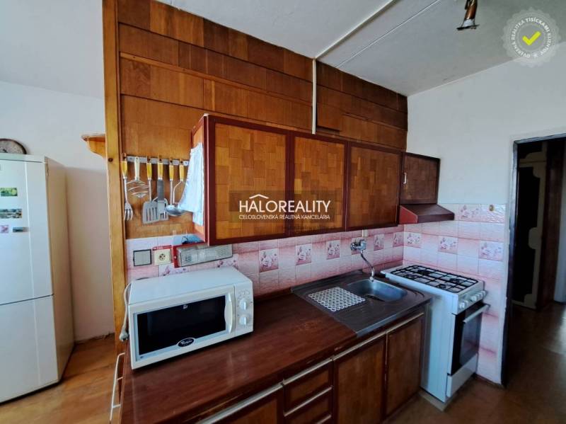 Living room in a 3-room apartment with sofas, wood-patterned flooring, and large windows.