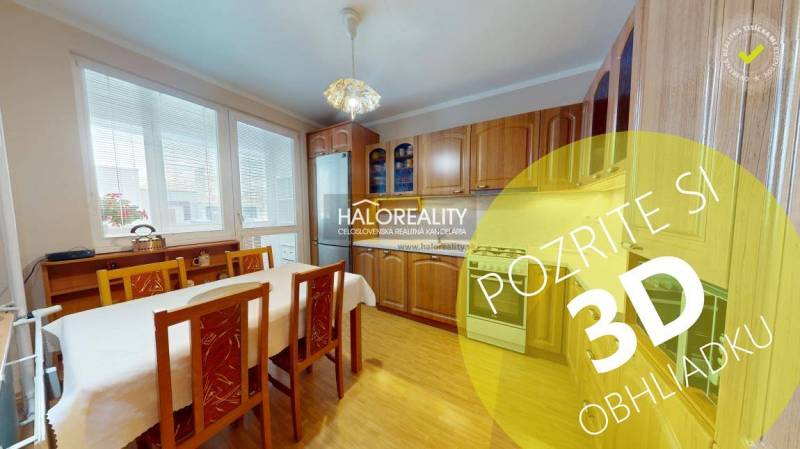 A kitchen in a 2-room apartment with a light wood decor and a dining table.