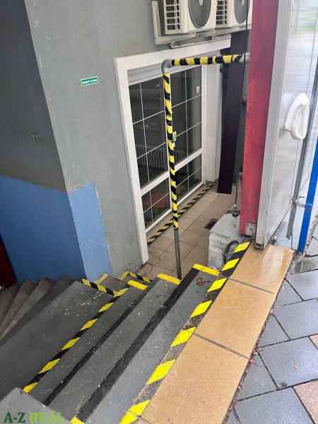 Stairs with safety features lead to the entrance of commercial premises on Račianska Street.