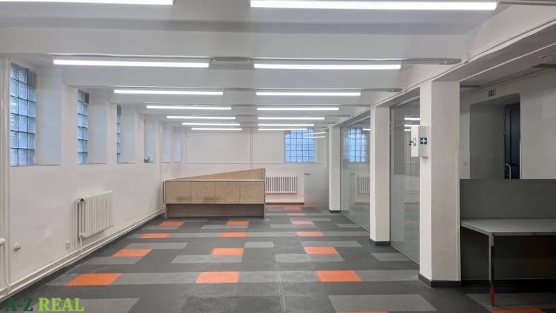 Commercial premises with a colorful floor and glass partitions, suitable for offices or operations.