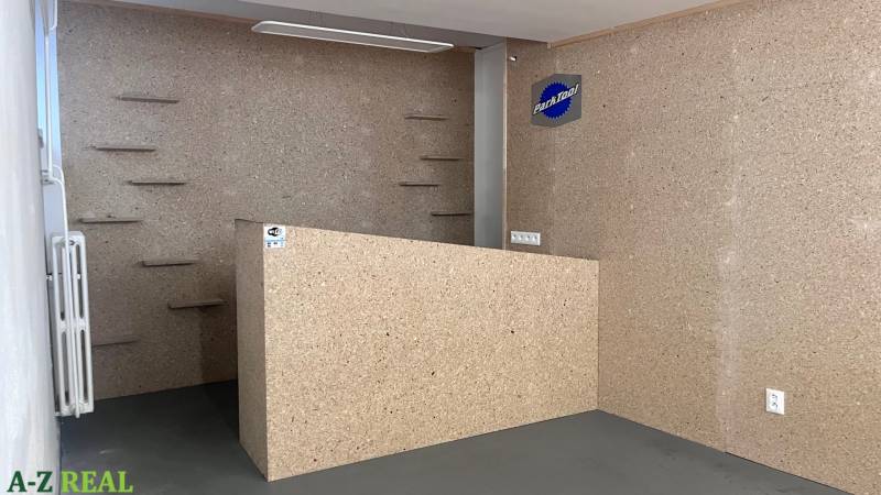 Interior of commercial spaces with wooden decor and shelves on the wall.