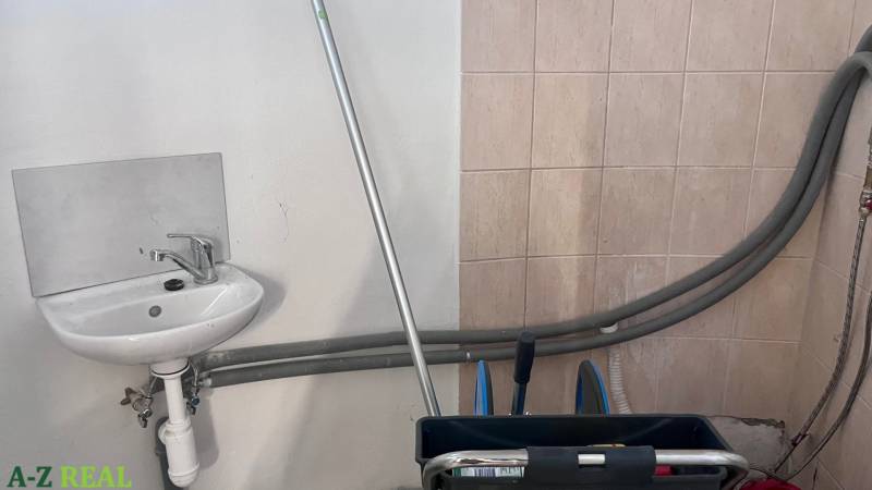 Sink and cleaning equipment in commercial premises.