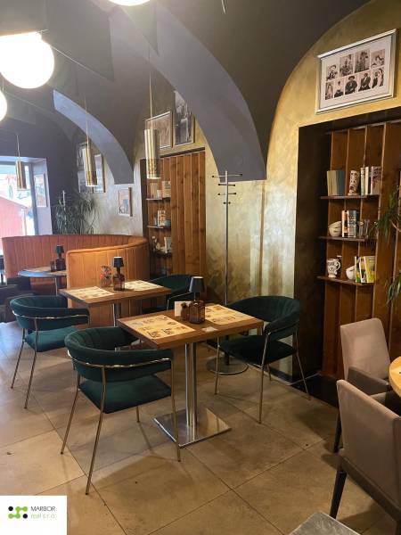 Gastro premises with vaulted ceilings, wooden decor, and comfortable seating.