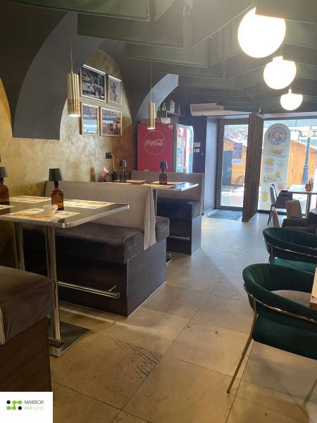 Interior of a gastro space with comfortable seating and decorative lighting.