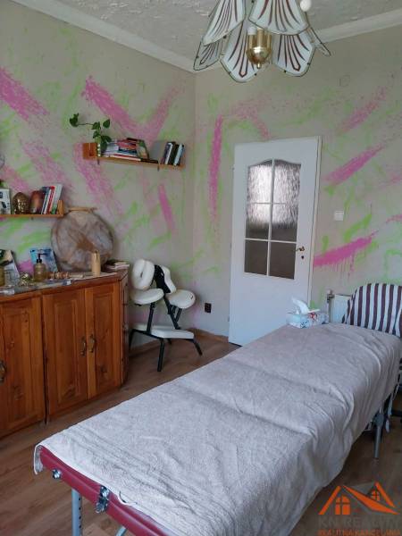 Massage room in a family house with colorful walls and a wooden decor floor.