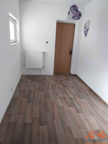 White wall, brown door, wooden decor flooring in a family house.