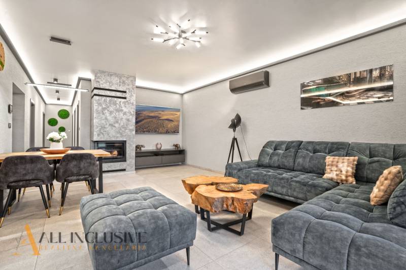 Interior of a family house with a comfortable sofa, fireplace, and wooden decor table.
