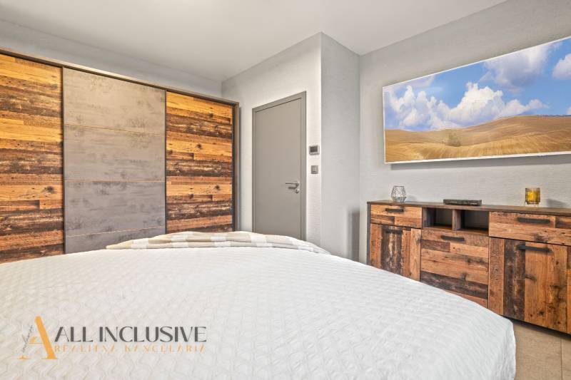 Bedroom in a family house with furniture and a wardrobe with natural wood decor.