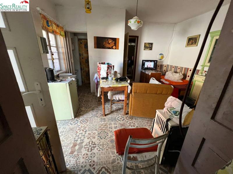 Interior of a family house with retro decor and decorative flooring. Rustic furniture and a stove.