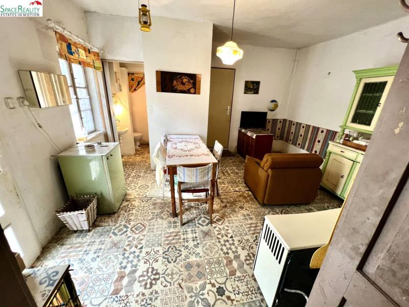 Interior of a family house, retro furniture, tiled floor, dining and living area.
