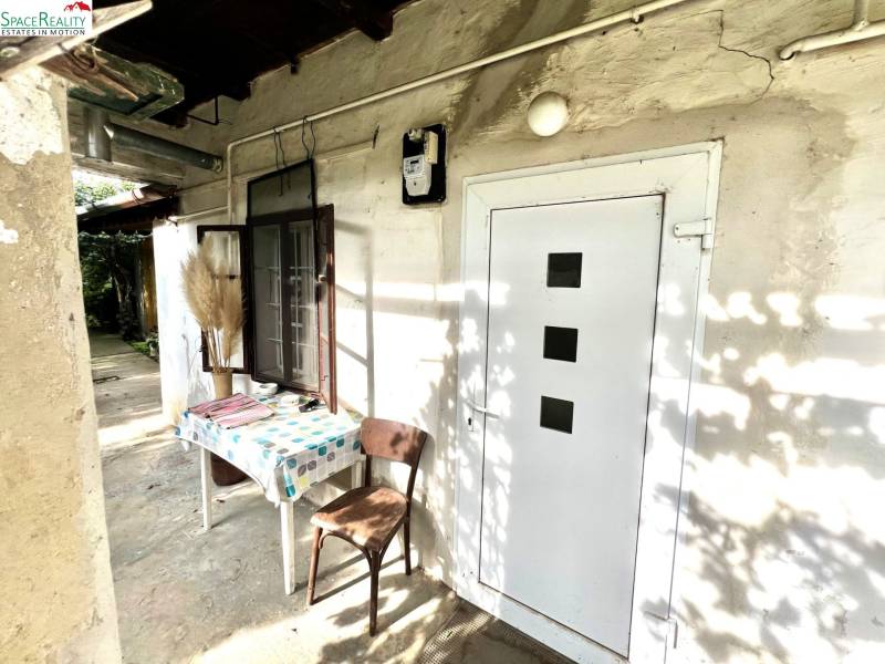 A family house in Jablonec with a table and a chair in the yard.