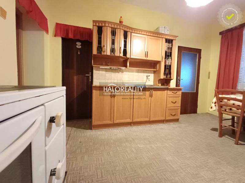 A kitchen in a family house with wooden cabinets and a classic stove.