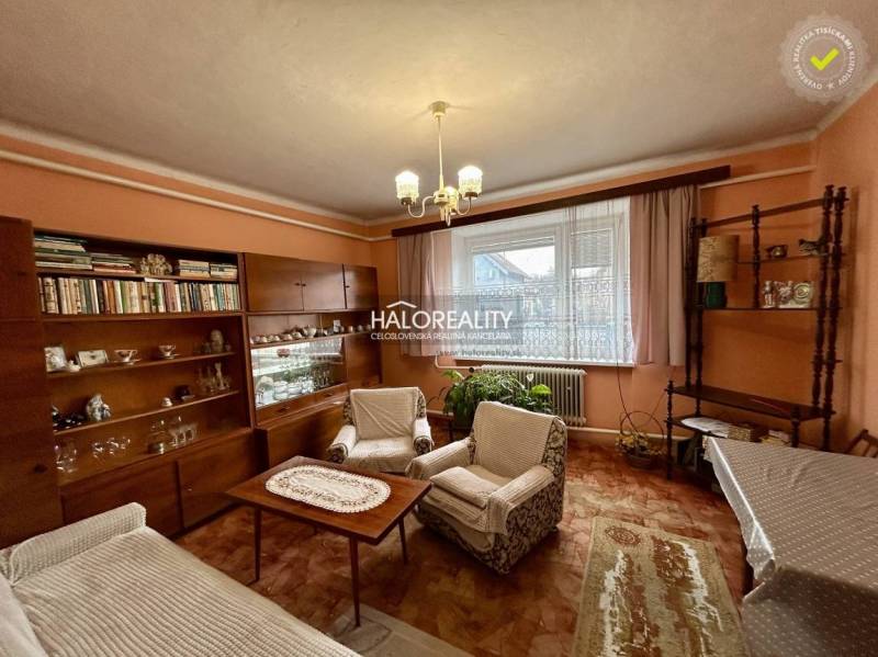 Living room of a family house with wooden decor furniture and curtains.