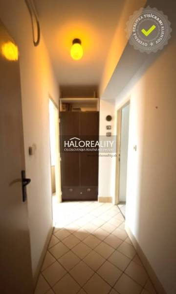 A hallway in a 3-room apartment with a built-in wardrobe and a ceiling light.
