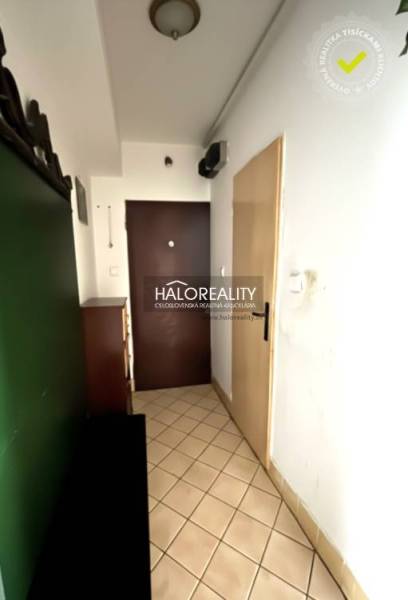 Entrance hallway of a 3-room apartment with tiles and furniture.