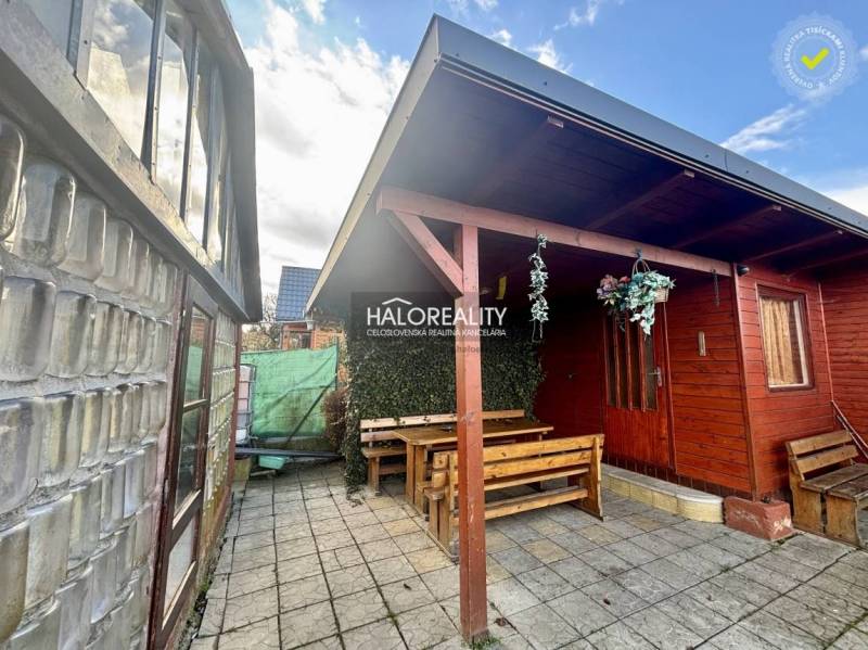 Wooden gazebo with a table and benches in the gardens of Spišská Nová Ves.