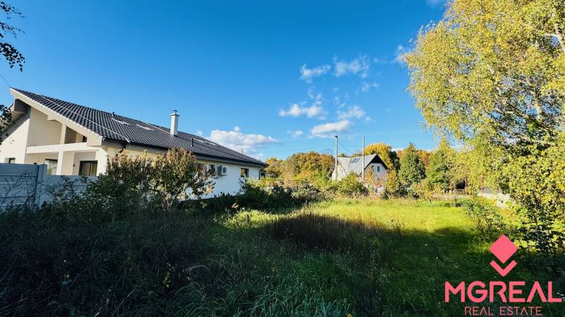 A family house in Brodzany surrounded by greenery and a clear blue sky.
