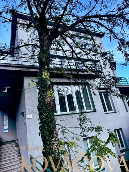 A building on M.R. Štefánik Street in Trenčín, with offices, surrounded by trees.