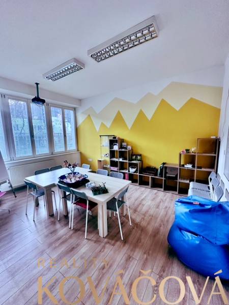 A colorful office with a wood-patterned floor, a desk, and chairs. A great working environment.