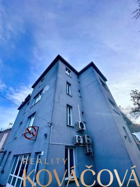 An office building on M.R. Štefánik Street in Trenčín under the blue sky.