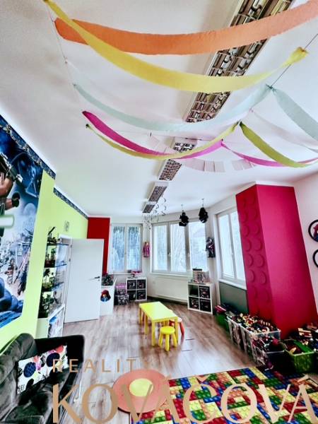 Colorful children's playroom with a wooden decor floor and vibrant decorations in the offices.
