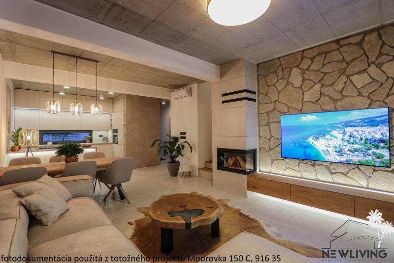 Living room in a family house with a fireplace, TV on a stone wall, and floor with wooden decor.