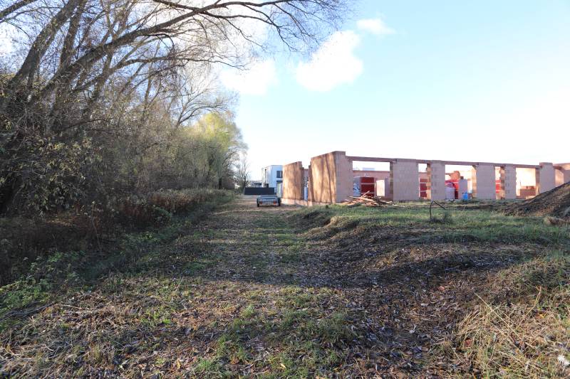 An unfinished family house on Drieňová Street in Nitra surrounded by trees and nature.